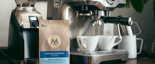 Home espresso machine and grinder with a bag of Modern Standard coffee