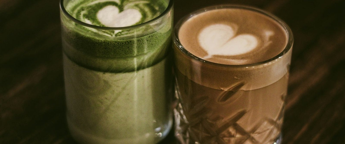 A matcha latte and a coffee latte side by side