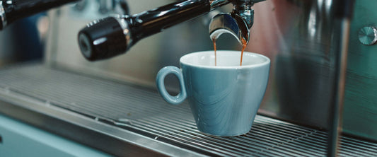 Espresso pouring into a blue cup