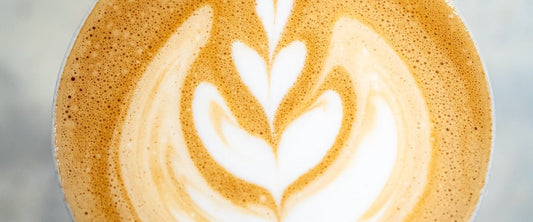 Flat white with tulip latte art, from above on marble