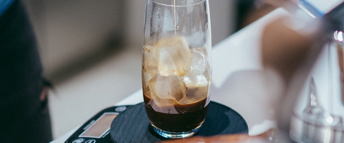 Pouring coffee over ice for an iced latte