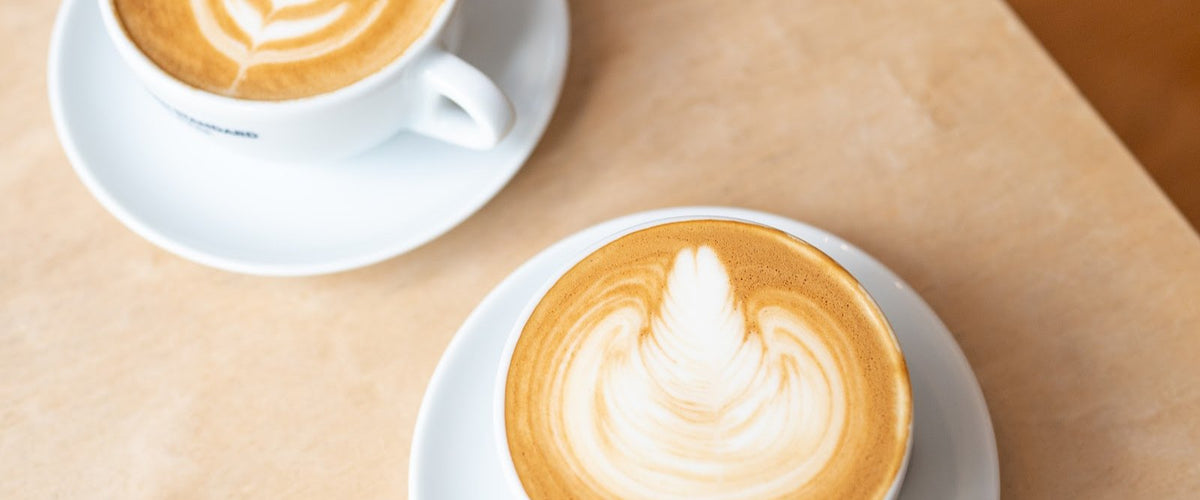 Latte with latte art on a café table
