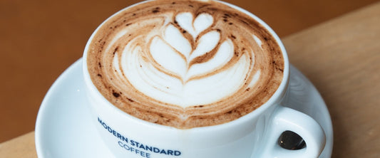 Mocha with latte art and chocolate dusting in a Modern Standard Coffee cup