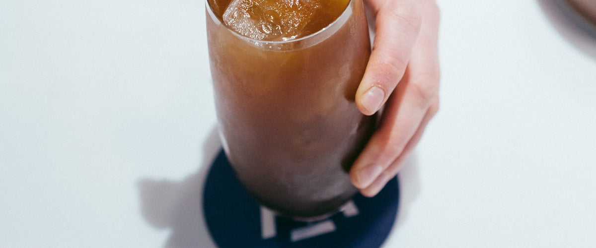 Glass of peach iced tea with ice