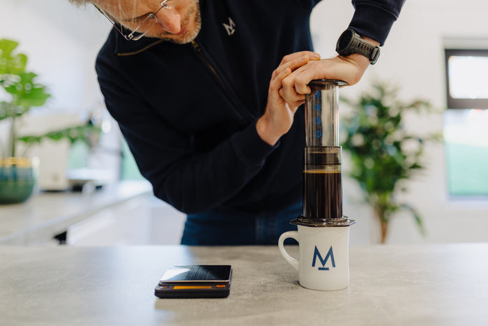 Pressing the flipped AeroPress down into a mug
