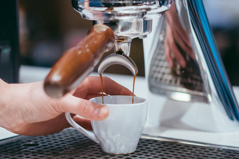 Espresso pouring from a portafilter into a white cup at Channel 4