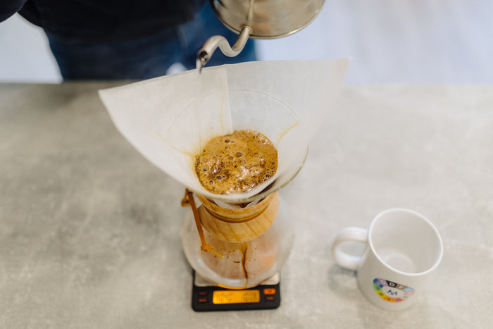 Pouring water in a spiral over the coffee in the Chemex