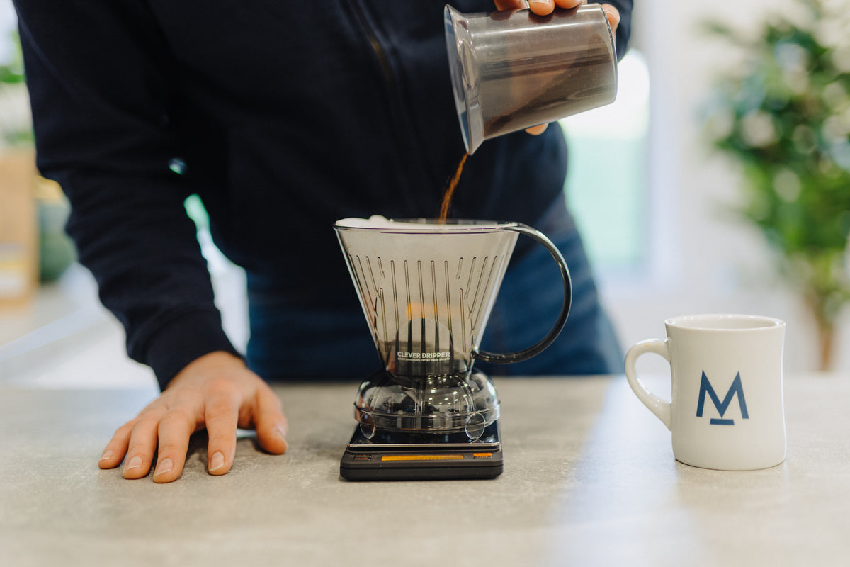 Pouring water into a Clever Dripper on digital scales