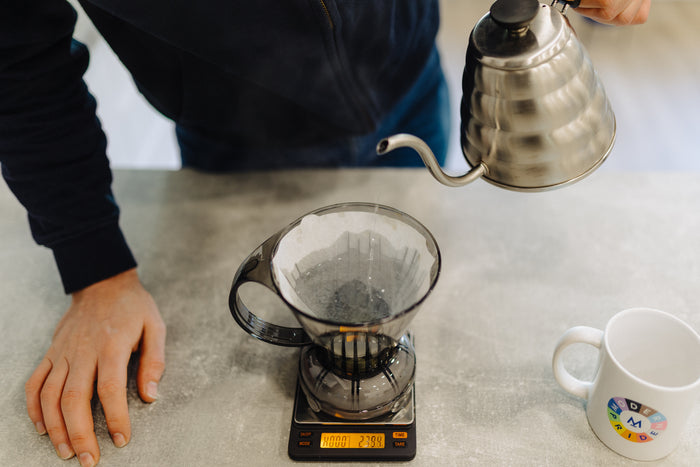 Rinsing the Clever Dripper filter over a mug