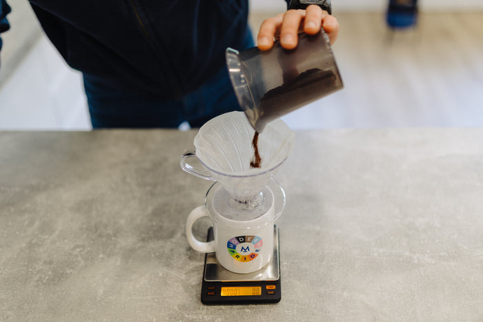 Ground coffee levelled in the V60 on digital scales