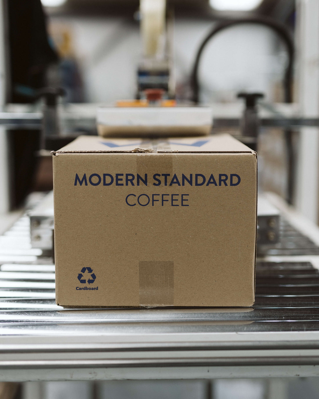 Modern Standard Coffee shipping box on the roastery packing line