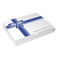 Modern Standard Coffee gift card box, closed, with a blue ribbon-and-bow lid