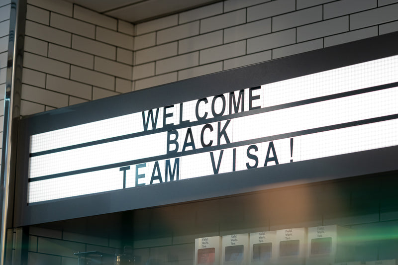 Welcome Back Team Visa sign above the coffee bar at Visa's London office