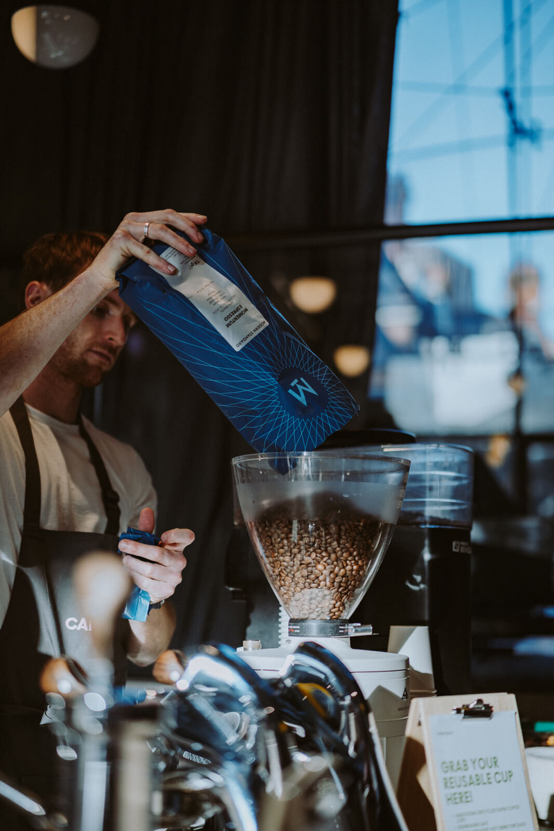 Barista refilling the grinder with Modern Standard Coffee at Channel 4