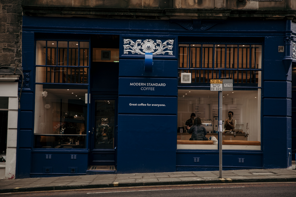 The navy blue shopfront of the Modern Standard café on Barclay Place, Edinburgh