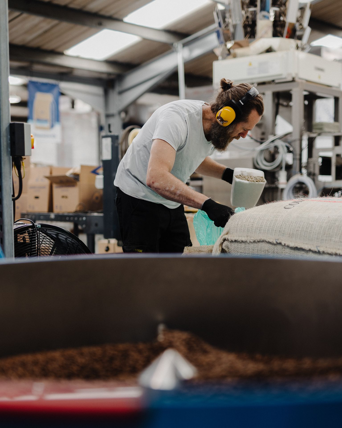 Coffee tipping out of a Diedrich roaster into the cooling tray