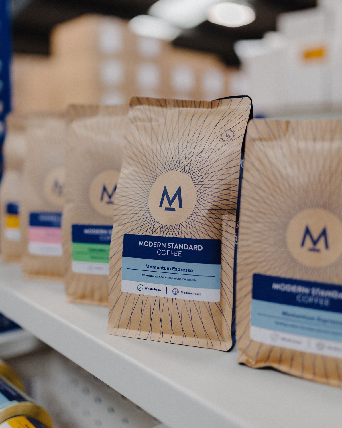 Bags of Modern Standard coffee on the roastery shop shelves